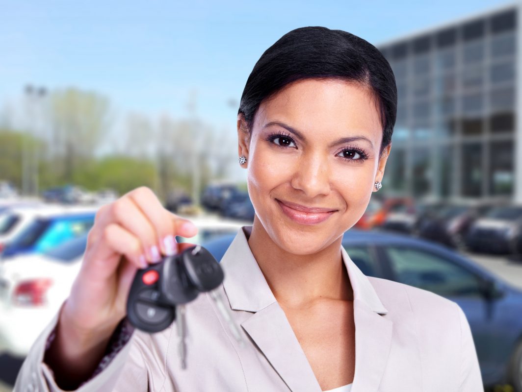 Woman with car key, leasing a car.